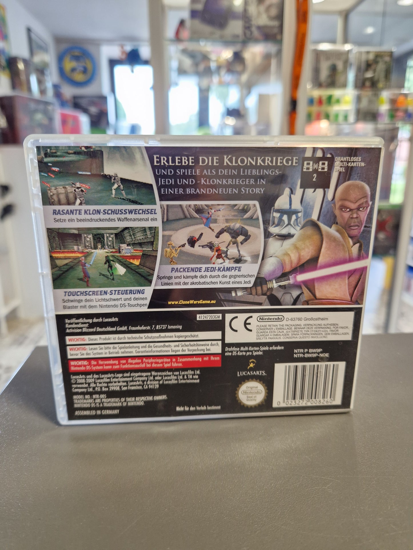 Die Rückseite der Star Wars Nintendo DS Verpackung mit Spielbeschreibungen zu den Klonkriegen, Screenshots der Level und der Touchscreen-Steuerung sowie dem Strichcode und dem Nintendo Qualitätssiegel.