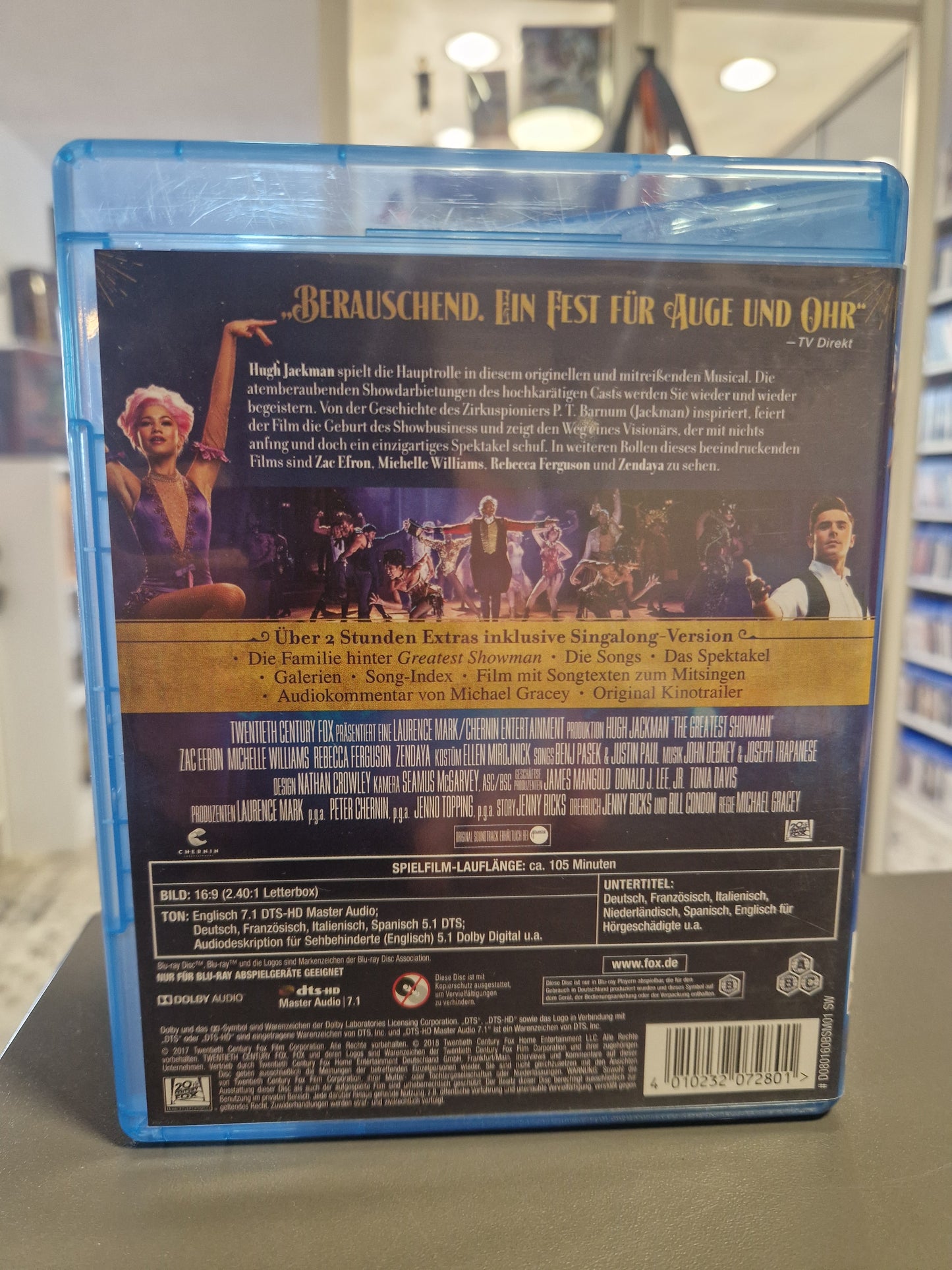 Rückseite der The Greatest Showman Blu-ray Hülle mit Filmübersicht, Extras, technischen Daten und Barcode 4010232072801.