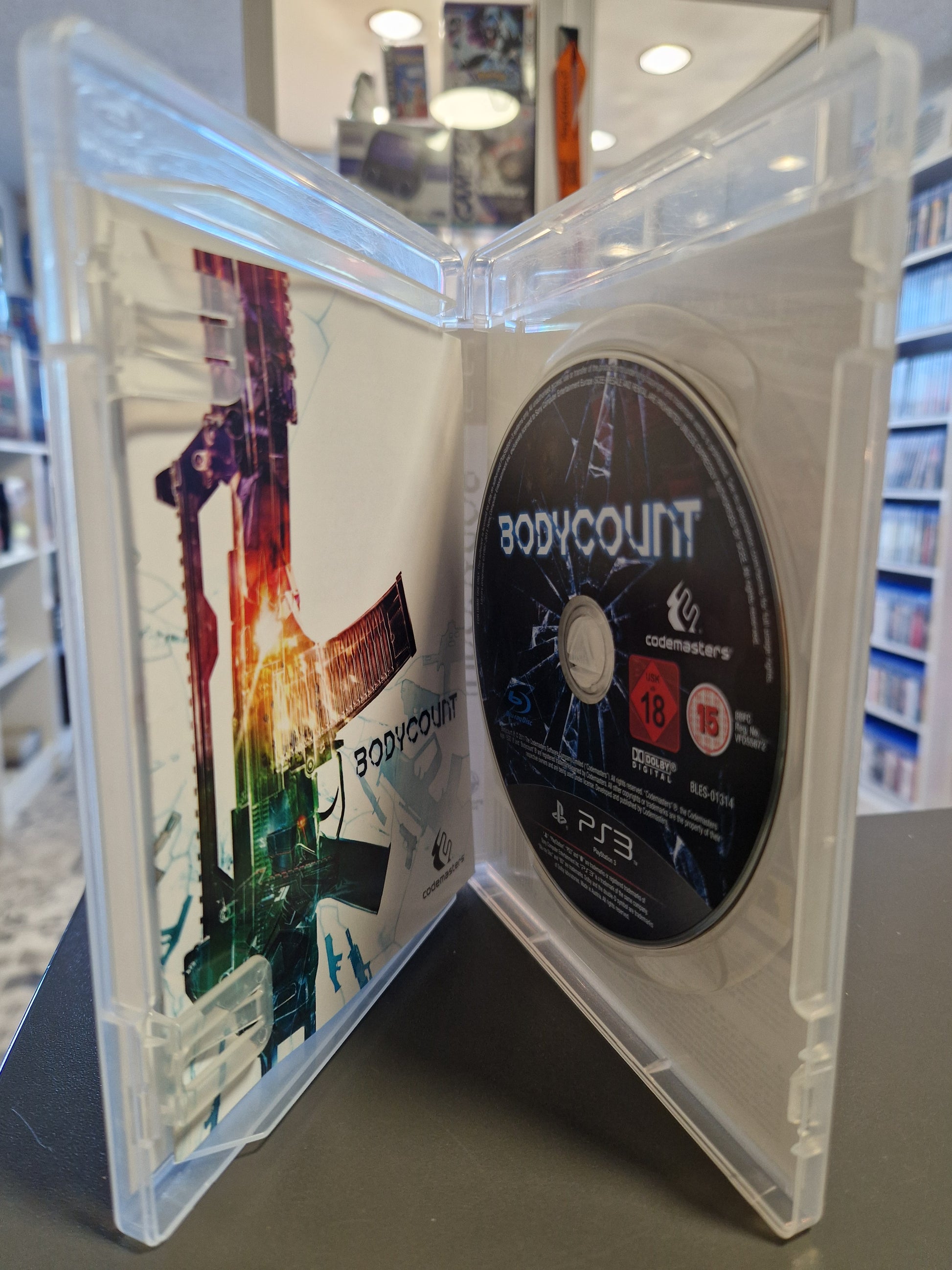 Geöffnete Bodycount PS3 Hülle mit kratzerfreier Disc, USK 18 Logo und Spieleanleitung.