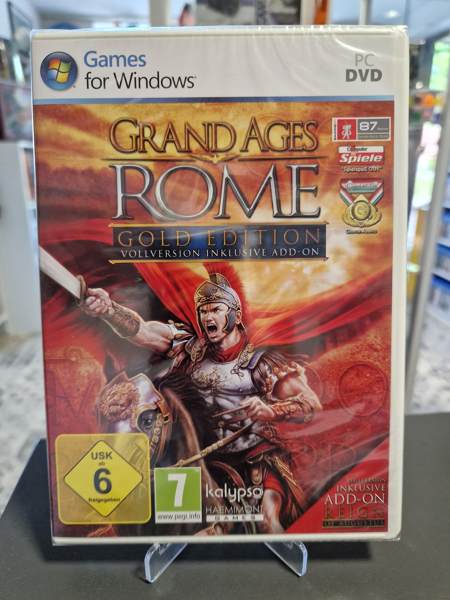 PC-Spiel Grand Ages Rome Gold Edition in der Originalverpackung (Sealed). Cover zeigt einen römischen General vor einer brennenden Stadt. Inklusive Add-on Reign of Augustus. USK 6 Logo.
