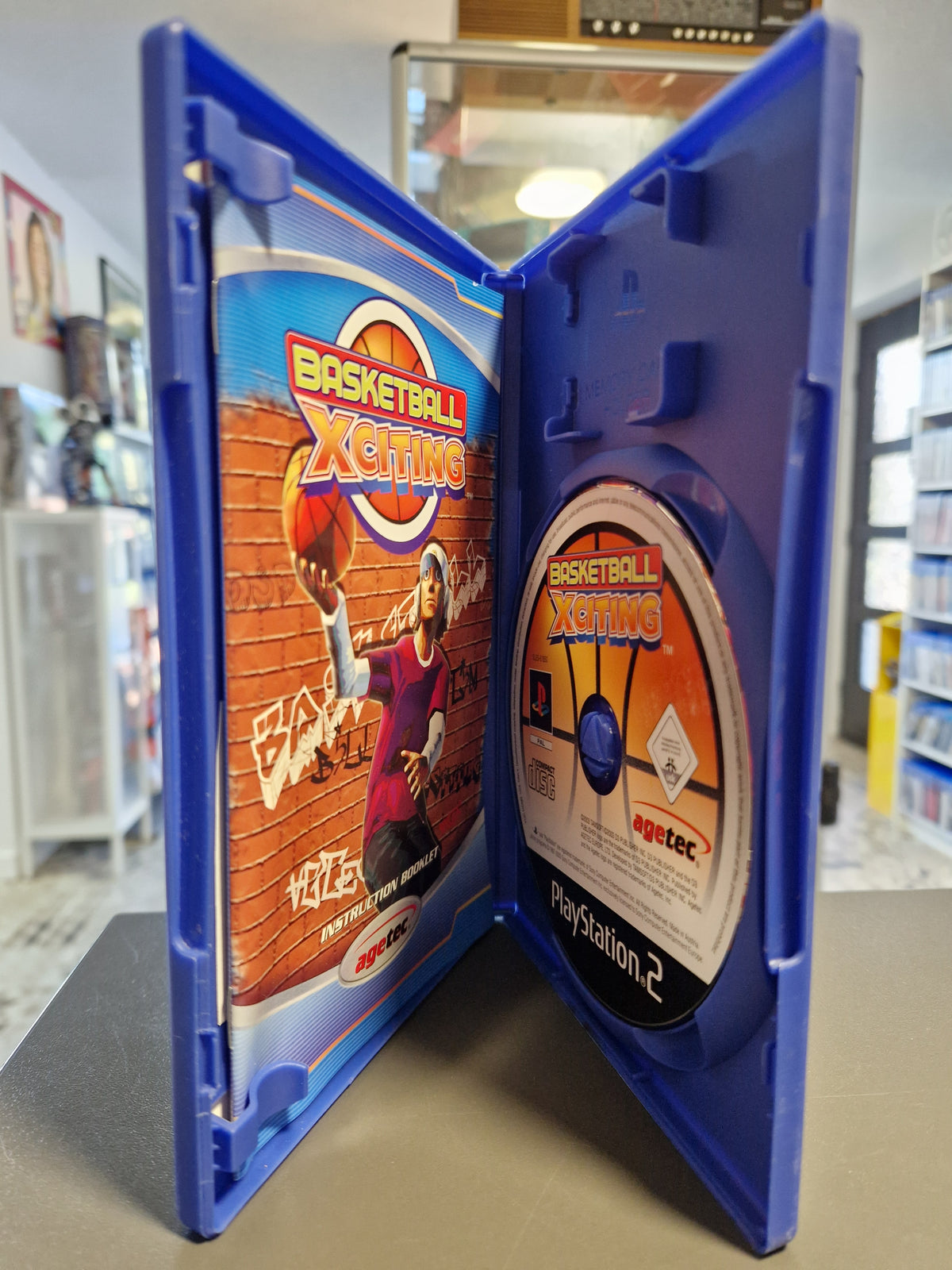 Geöffnete PS2 Hülle von Basketball Xciting mit CD-ROM und Anleitungsheft.