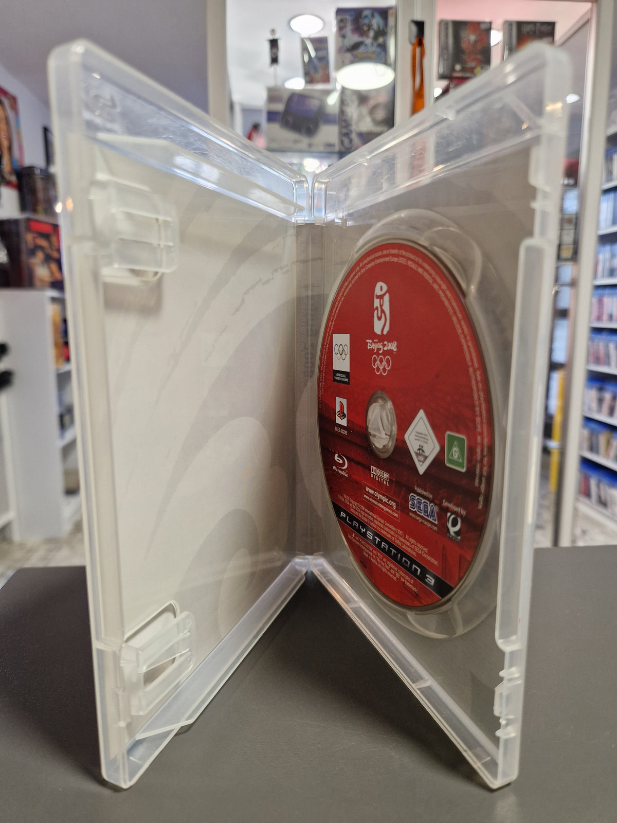 Geöffnete PlayStation 3 Hülle von Beijing 2008 mit der Blu-ray Disc.