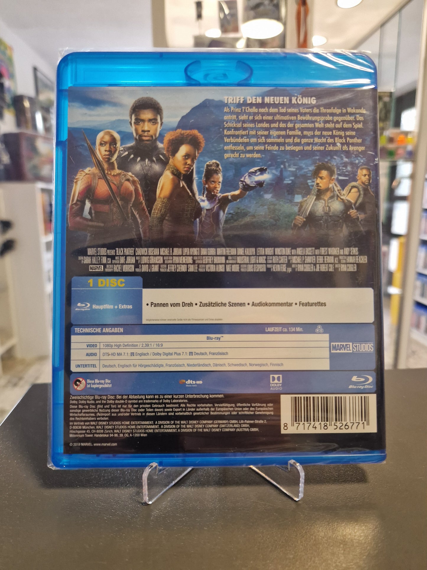 Rückseite der originalverschweißten Blu-ray-Hülle mit der Inhaltsangabe „Triff den neuen König“, technischen Angaben und einer Charakter-Collage der Hauptdarsteller.