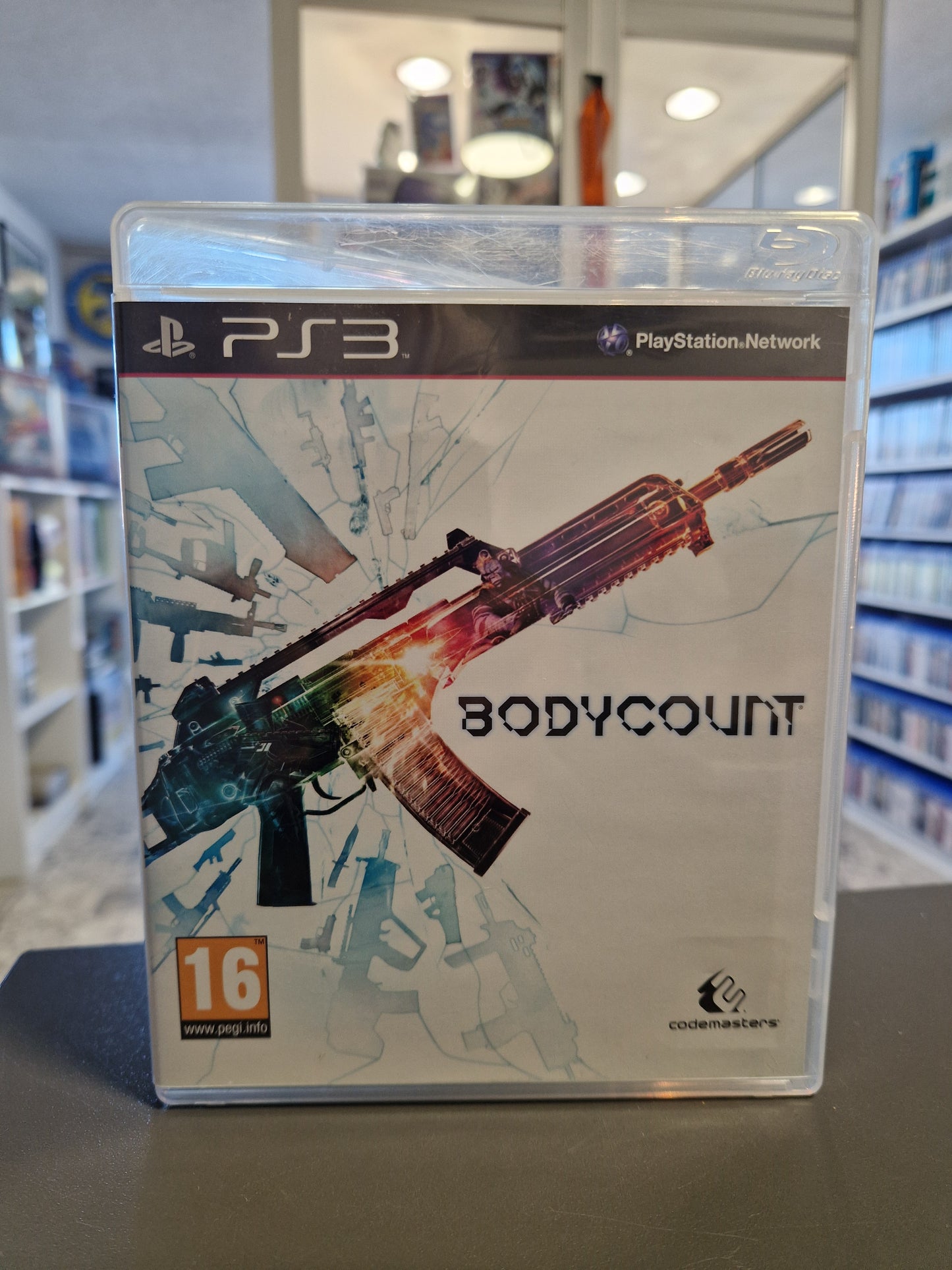 PS3 Spiel Bodycount Hülle Vorderseite mit Sturmgewehr-Artwork und PEGI 16 Logo.