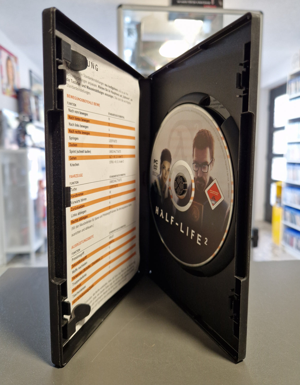 Geöffnete PC Hülle von Half-Life 2 mit DVD-ROM und Tastenbelegungs-Beilage