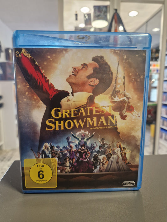Vorderseite der Blu-ray Hülle von The Greatest Showman mit Hugh Jackman und gelbem FSK 6 Logo.