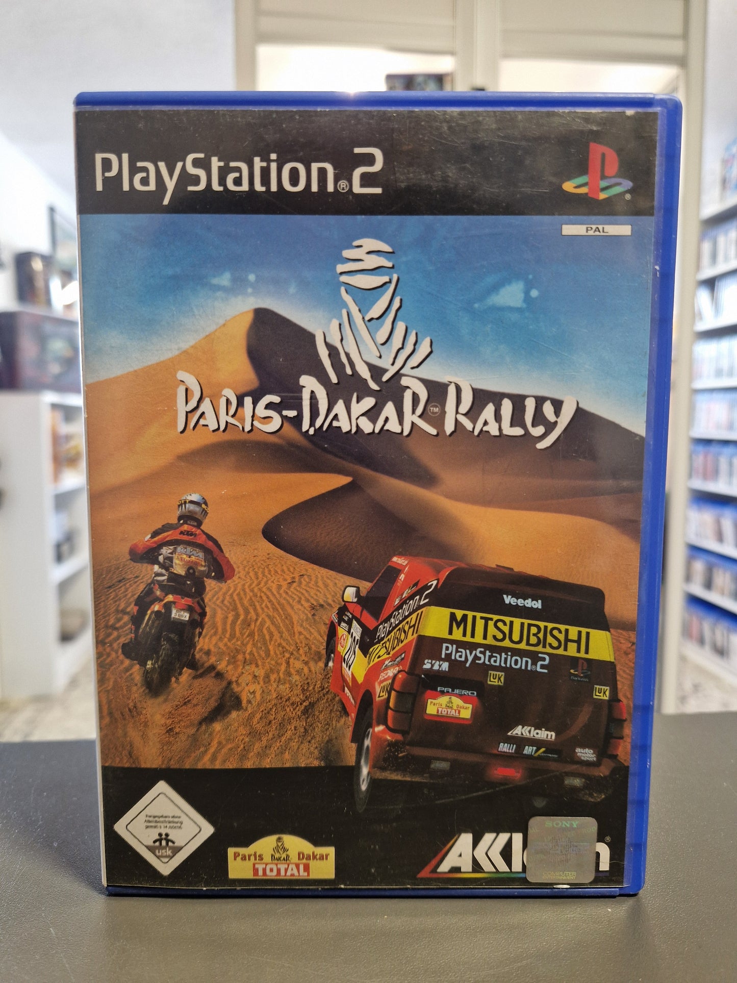 Vorderseite der PlayStation 2 Hülle von Paris-Dakar Rally mit USK 0 Logo.