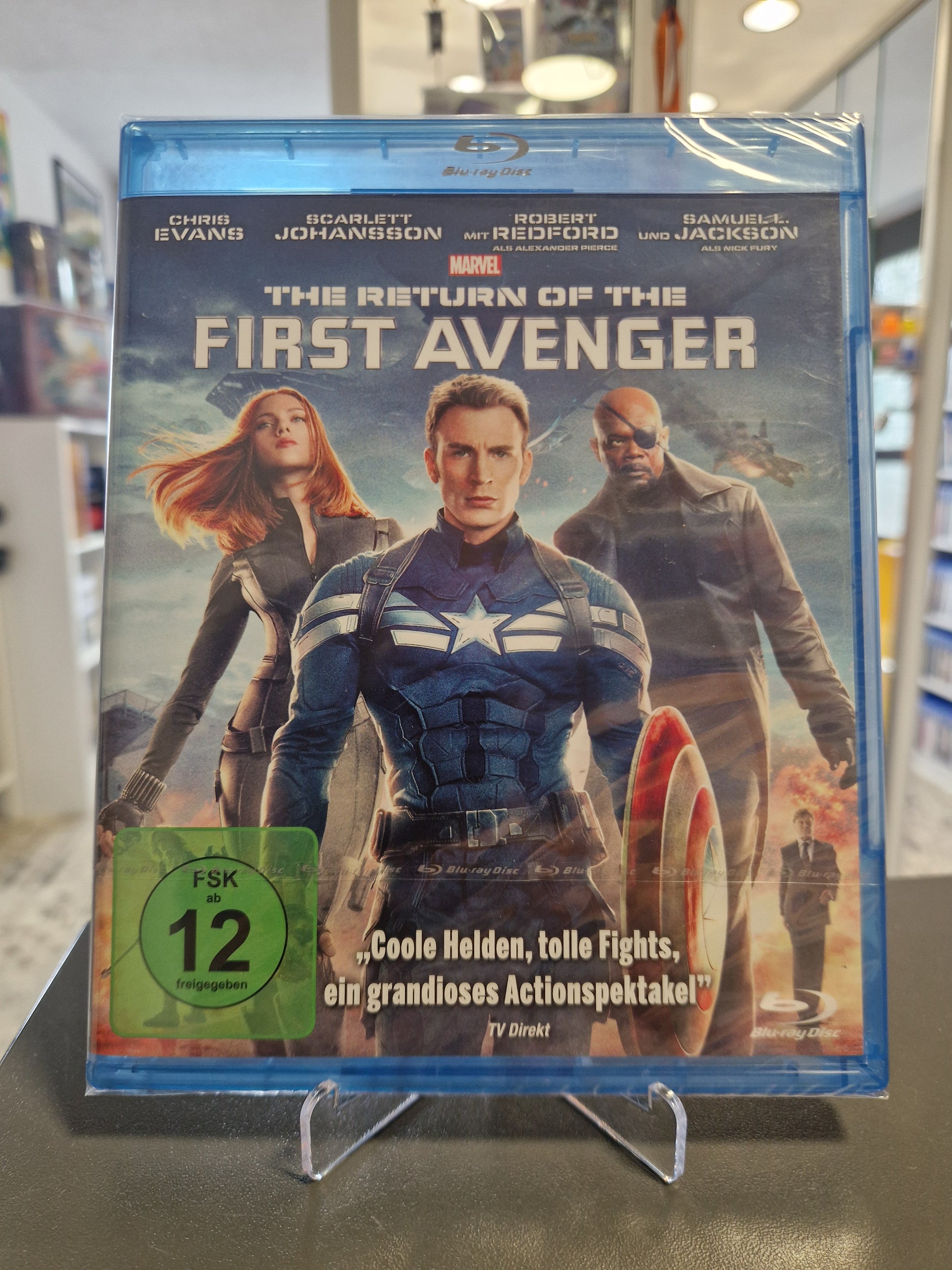 Blu-ray-Cover von „The Return of the First Avenger“ in originaler Schutzfolie zeigt Chris Evans als Captain America mit seinem Schild, Black Widow und den maskierten Winter Soldier im Hintergrund.