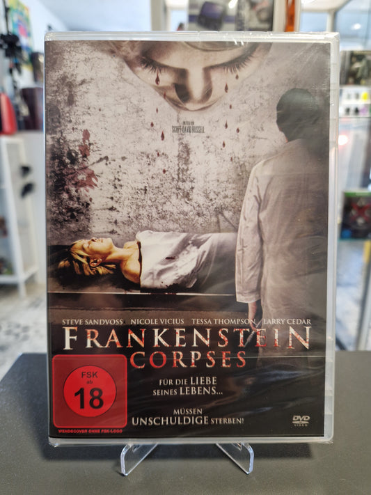 Originalverpackte und in Schutzfolie verschweißte DVD des Horrorfilms Frankenstein Corpses mit rotem FSK 18 Logo. Das Cover zeigt einen Arzt im Kittel vor einer Frau auf einem Seziertisch sowie weinende Augen im Hintergrund.