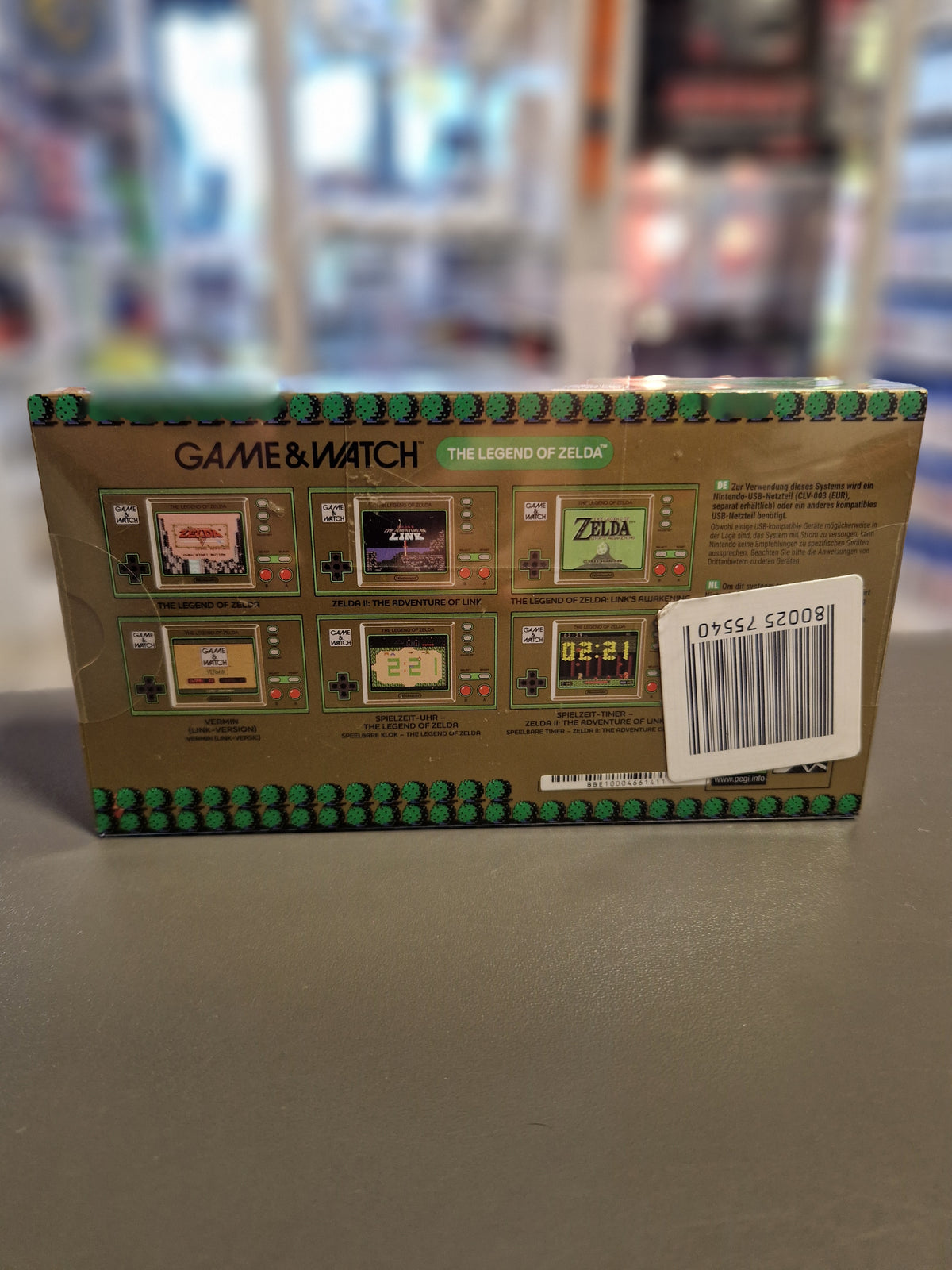 Rückseite der Verpackung der Game and Watch Zelda Handheld Konsole mit Spielübersicht.